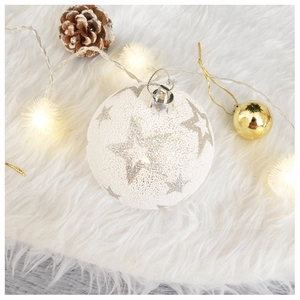 Close-up of white glitter star Christmas ball ornament on soft plush background