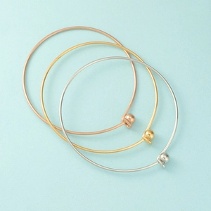 Three-piece stainless steel bangle set in gold, silver and rose gold with bead clasp