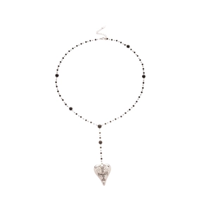 Collier cœur en argent avec relief croix et perles noires sur fond blanc