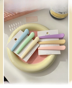 Macro view of 6-piece matte macaron hair clips set on a stylish display card