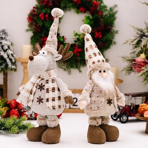 Close-up of reindeer and gnome plush dolls with knitted hats for Christmas decor