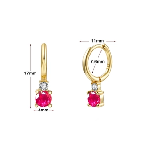 Macro view of gold-plated silver earrings with 4mm ruby-red stone and 925 silver stamp