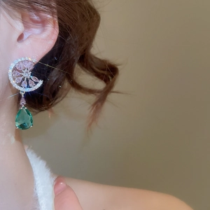 Silver needle earrings featuring pink rhinestones and a green teardrop-shaped gemstone drop