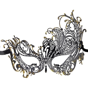 Detailed view of black and gold laser-cut masquerade mask with glitter and satin ribbons
