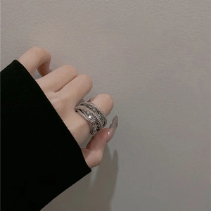Detail of a layered silver band ring featuring sparkling cubic zirconia stones