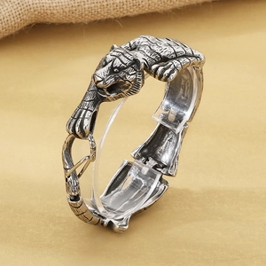 Macro view of vintage tiger head relief on antique silver finish titanium steel bracelet