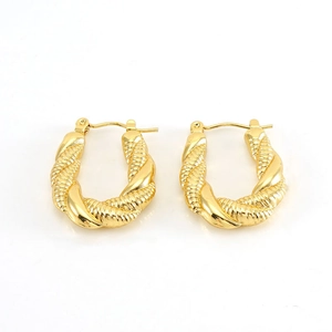 Close-up of golden stainless steel twist rope earrings in an oval U-shaped hoop design