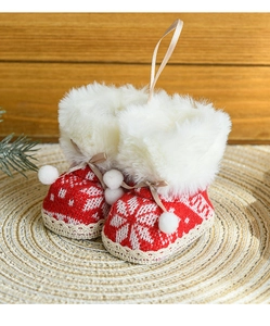 Detailed close-up of a red knitted Christmas boot ornament with faux fur trim and lace tie