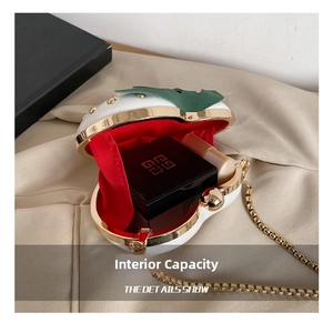 Detail view showing interior capacity of white strawberry bag with gold metal trim