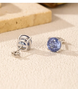 Close-up of S925 sterling silver stud earrings featuring tanzanite-colored round cut stones
