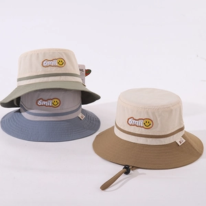 Detail of embroidered smile patch and adjustable windproof cord on bucket hats