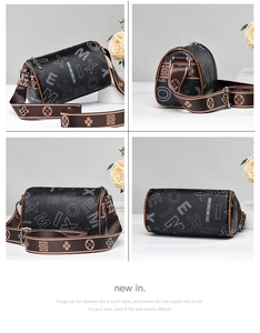 Detail view of black Boston bag with white monogram print and brown patterned strap