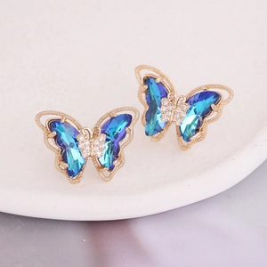Macro detail of gradient blue and purple butterfly earrings with micro-inlaid zircons