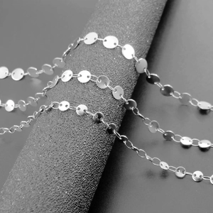 Macro detail of silver stainless steel disc chain showing polished round links for DIY jewelry