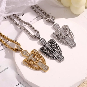 Detailed view of 18K gold, silver, and gunmetal cross pendants with cubic zirconia