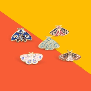 Detailed set of five moth enamel pins featuring moon phases and celestial starry patterns