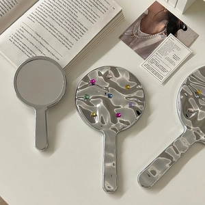 Elegant silver handheld makeup mirror with water ripple texture and colorful gemstones