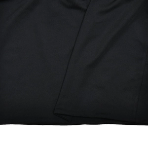 Detail shot showing the soft black knit texture and elegant draped fabric of the mini dress