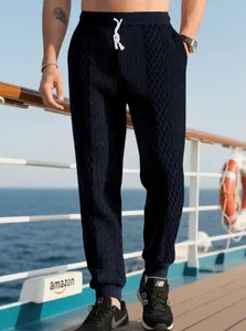 Detail of navy waffle knit joggers featuring white drawstring and elastic waistband