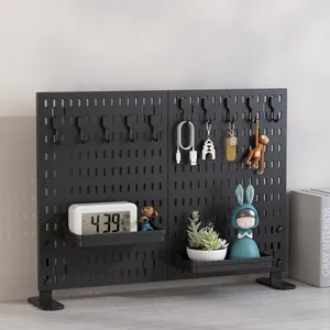 Modern black pegboard organizer with hooks and shelves for desktop storage and workspace setup