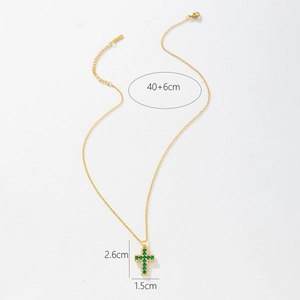 Detailed view of gold cross pendant with green and white zircons and size specifications
