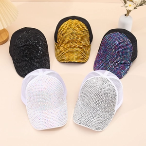 Detail of five glittering trucker hats with rhinestone embellishments in multiple colors