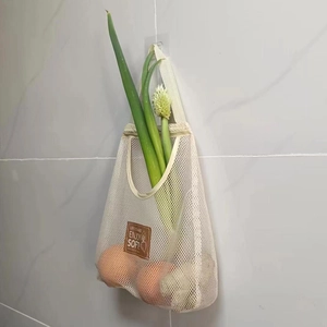Close-up of cream mesh produce bag for onions and garlic with leather patch detail