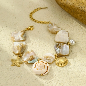 Golden beach bracelet with natural shell, starfish charms and pearls for women