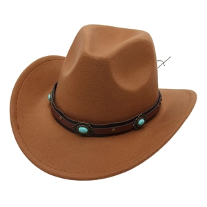 Detail of western brown felt cowboy hat with turquoise beads and metal studs band