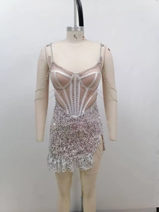 Detail of pink sequin mini dress featuring rhinestone corset and beaded chain tassels