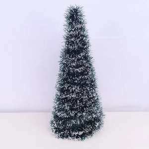 Miniature Christmas tree with red berries, green needles and white snow effect decor