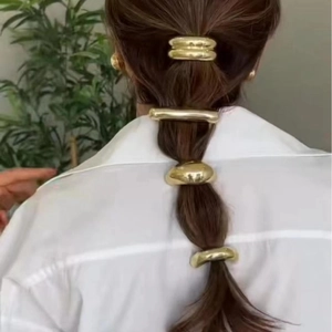 Minimalist gold elastic hair ties for women with creative metallic finishes and sleek shapes
