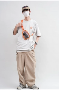 Transparent candy-colored PVC crossbody chest bag with orange strap shown worn by a model