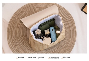 Top-down view of woven small bag interior showing wallet, perfume, and lipstick