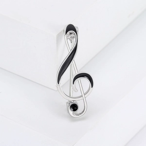 Elegant silver treble clef musical note brooch with black enamel and sparkling rhinestones