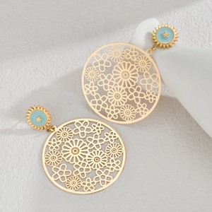 Detail of gold hollow flower earrings with light blue sun pattern and gold star centers