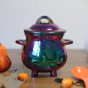 Macro view of iridescent witch cauldron mug with metallic sheen and tripod feet