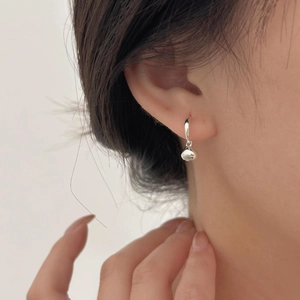 Elegant 925 sterling silver bean shaped hoop earrings shown on model for daily wear