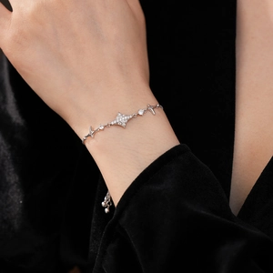 Close-up of elegant silver starburst bracelet with sparkling zircon stones on wrist