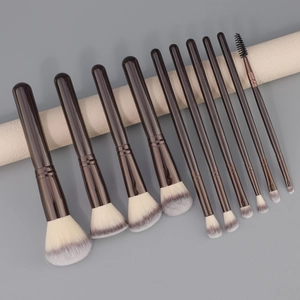 Professional 10-piece makeup brush set with gradient bristles on a minimalist gray background