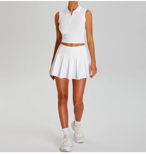 Detail of white sleeveless polo crop top and pleated skirt for tennis and outdoor sports