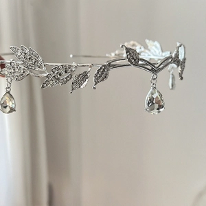 Detail of silver leaf tiara with sparkling rhinestones and teardrop crystal pendants