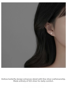 Detail of a 925 sterling silver butterfly stud earring worn on the earlobe