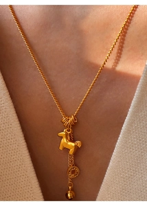 Close-up of 24K gold plated necklace featuring a 3D pony and copper coin pendant