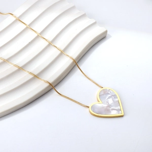 Golden heart pendant necklace with white shell inlay on a delicate snake chain