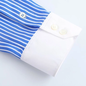 Detailed close-up of blue and white striped shirt cuff with elegant white contrast design