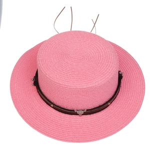 Detailed top view of pink woven flat top sun hat with bull head stud and black band