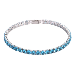 Detail of silver tennis bracelet with square-cut blue zircons on white background