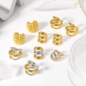 18K gold plated stainless steel ear cuffs and ear clips displayed on minimalist props