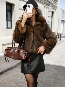 Close-up of fluffy brown faux fur texture and wide lapel collar on a winter jacket